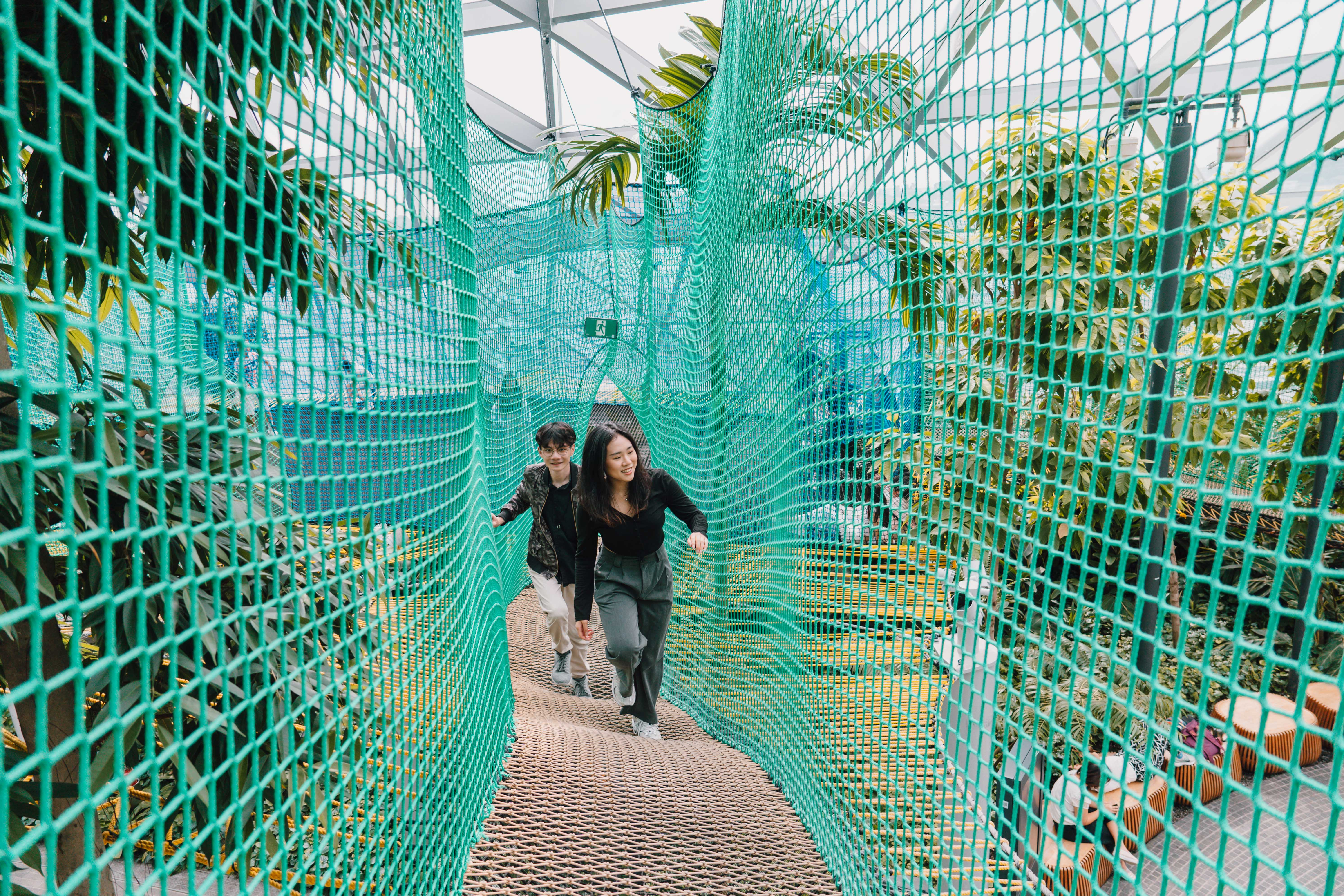 2 people walking through the Bouncing Nets