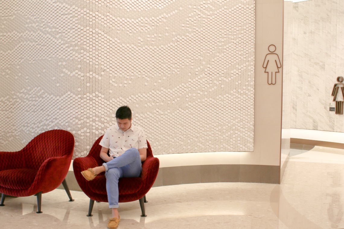 Red lounge chairs at the entrance of a toilet at Changi Airport