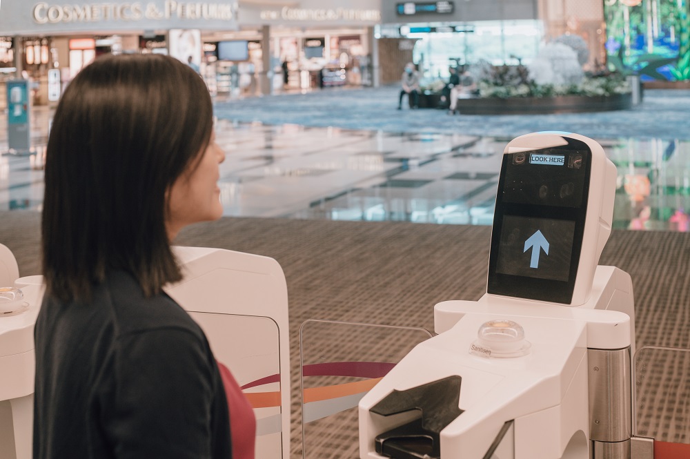 A passenger using the multi-modal biometric system at the immigration clearance