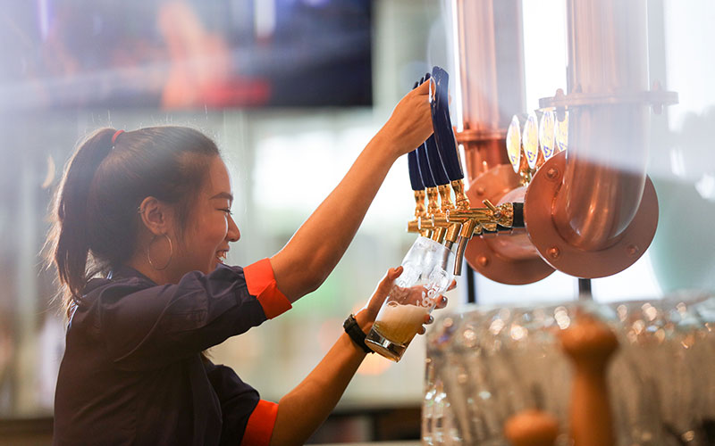 Bartender drafting a smooth, ice cold beer
