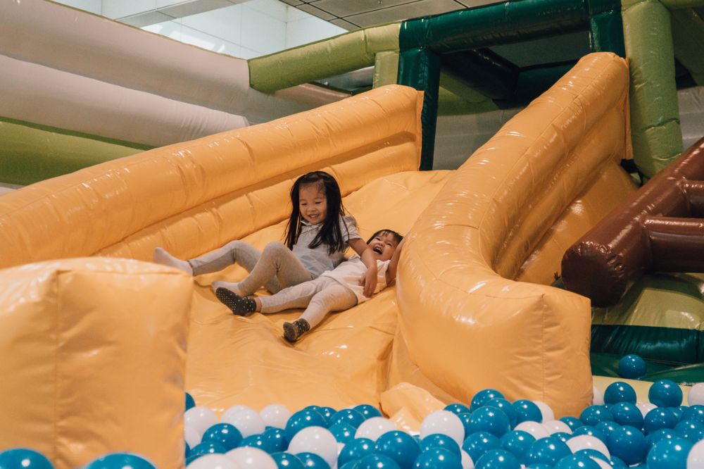 Slide in a bouncy playground and a ball pit for absolute fun