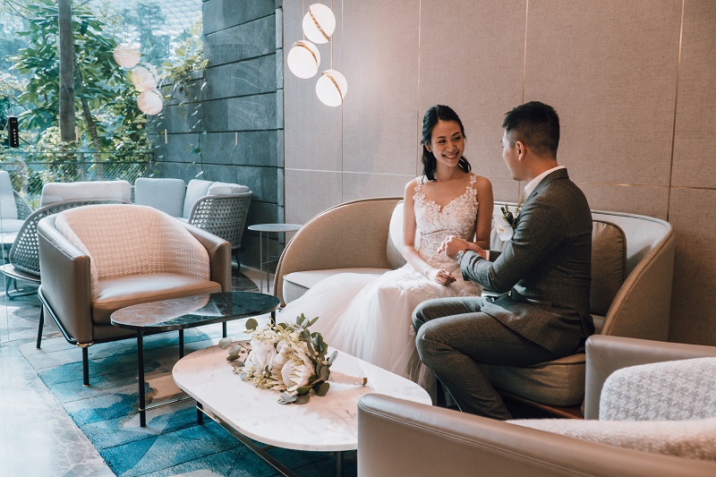 couple toasting to drinks at a small wedding party lounge at the jewel suite, singapore changi airport