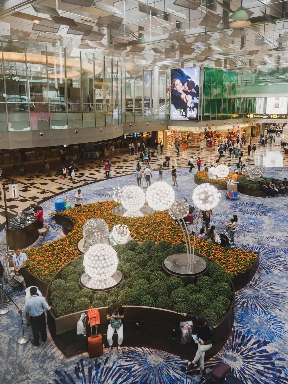 A top-down wide shot of the Crystal Garden in Terminal 3.