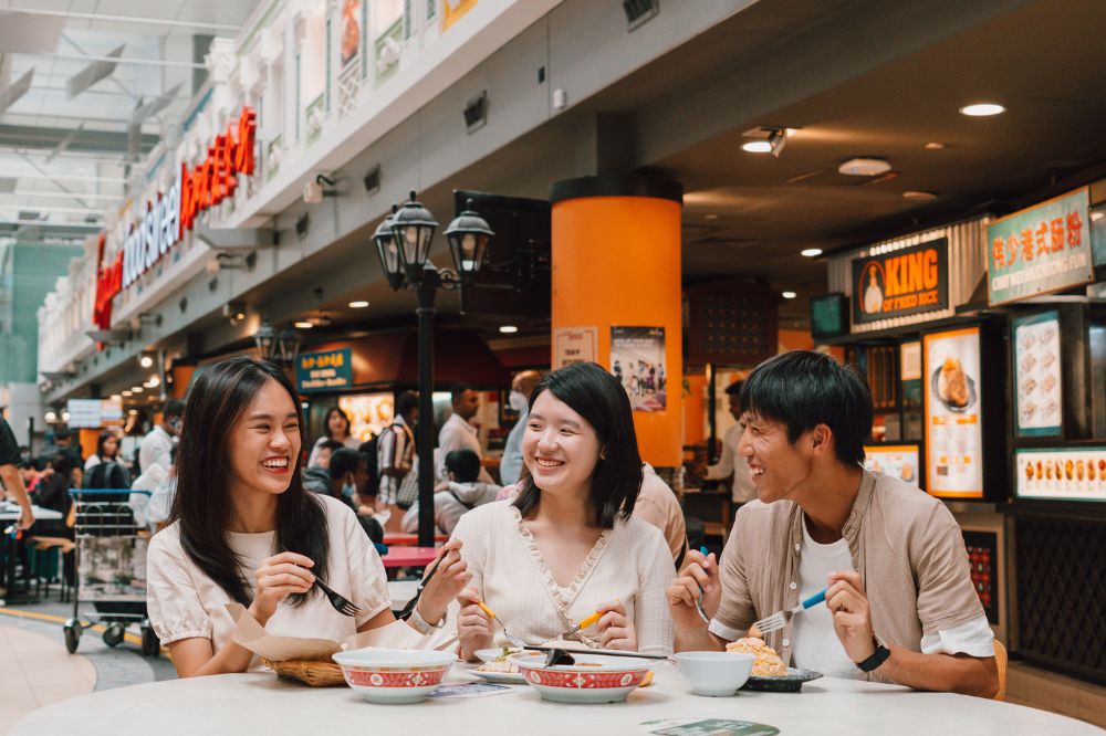 Group of friends enjoying food at Changi Airport