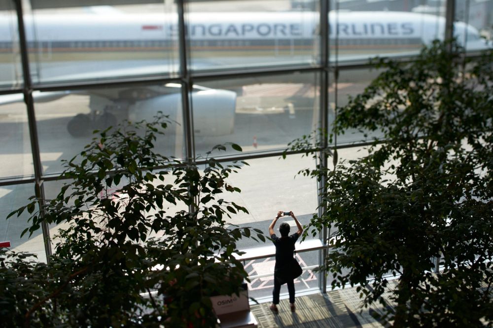 Plane spotting full length window at Changi Airport