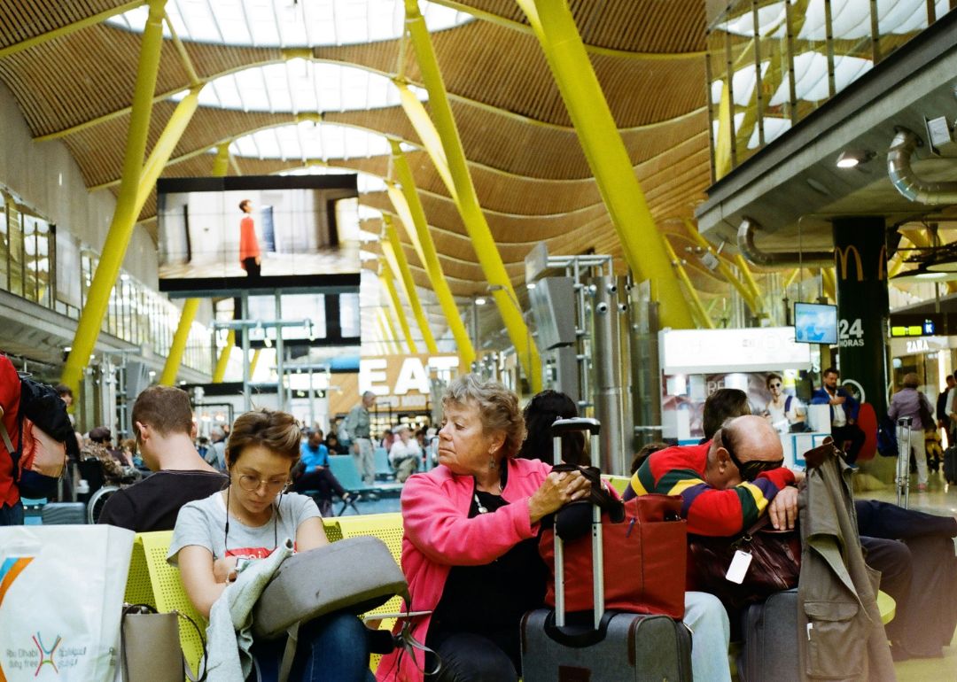 travellers waiting for codeshare flight information in an airport