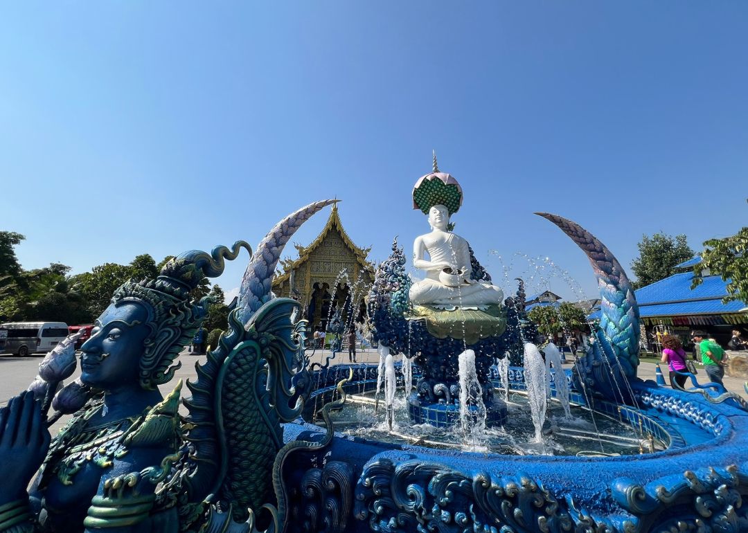 chiang rai blue temple fountain statues
