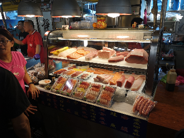 Market vendor selling fresh sashimi 