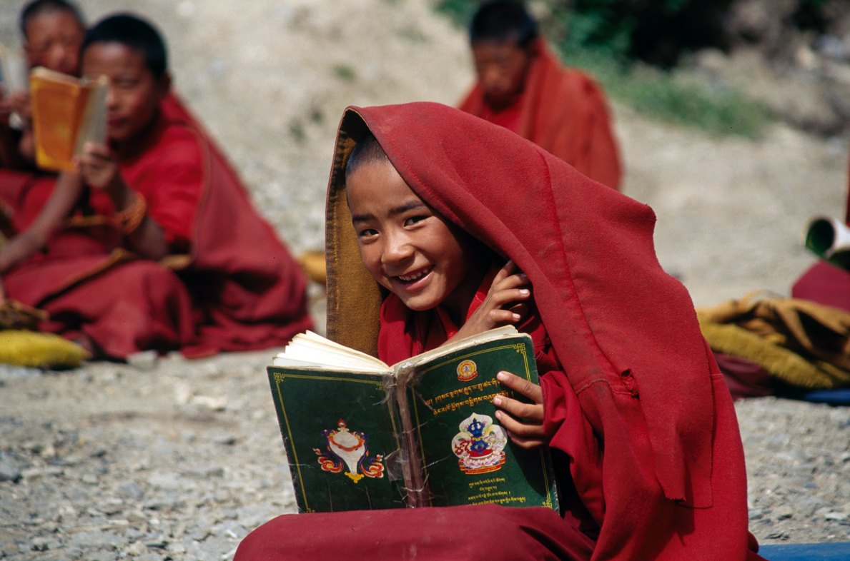 A monk, flashing a bright smile
