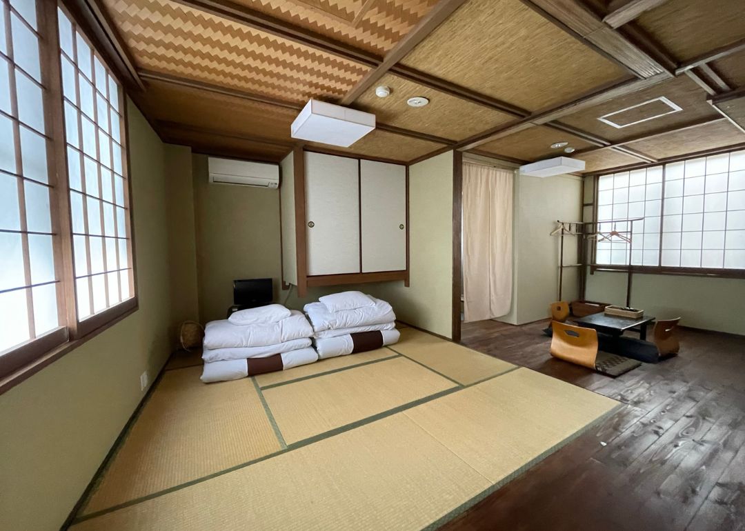 room in sangen kyoto ryokan with tatami mat flooring futon traditional furniture