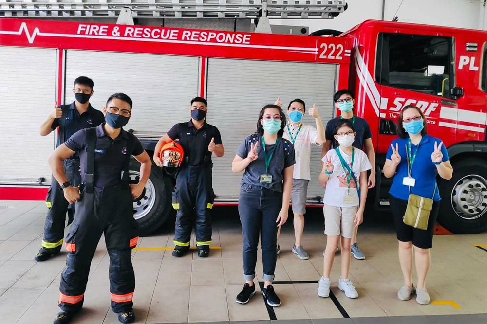 Singaporeans posing for a we-fie at a neighbourhood fire station in Singapore