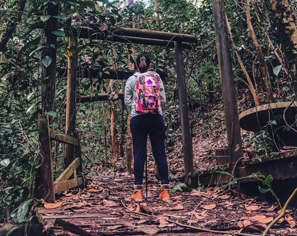 a lady hiking on a trail at bukit batok hillside park in singapore