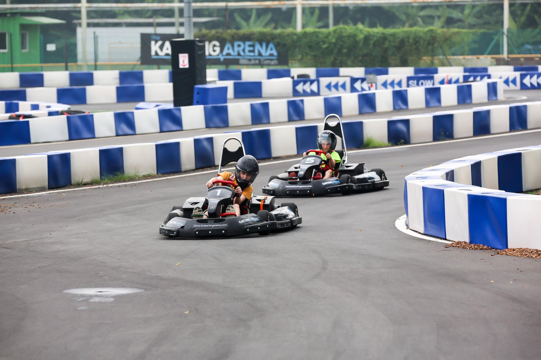 kids riding at the go kart circuit at the karting arena, north west of singapore