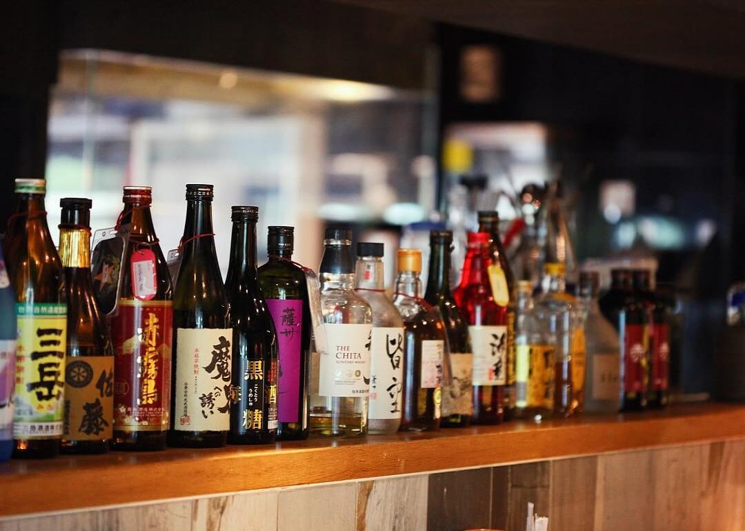 bottles of sake on display at shunjuu