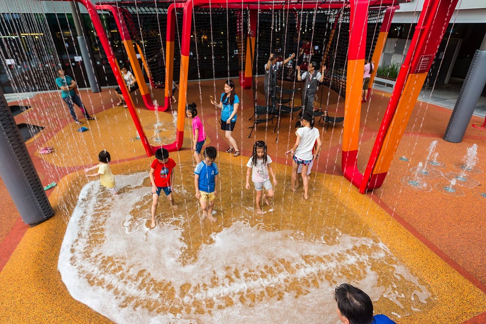 a group of children playing at the waterpark at jem shopping mall, west singapore