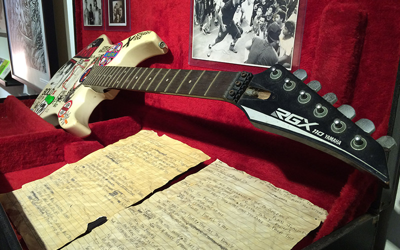 Actual lyrics-sheets and guitar belonging to Singapore music veteran, Suhaimi Subandie.