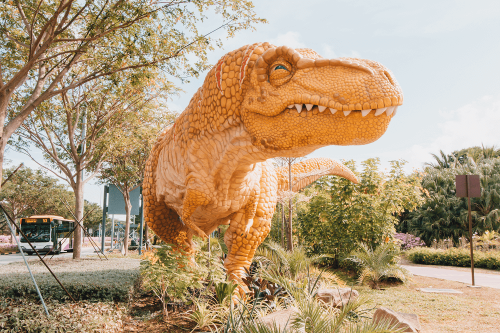 A yellow T-Rex exhibit along Airport Boulevard